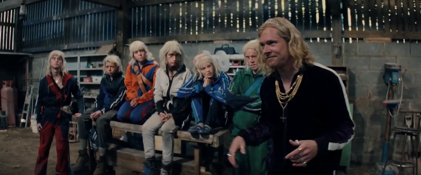 Sir Jimmy Crystal addressing his tracksuit-clad, bleach-blond followers in a barn strung with fairy lights