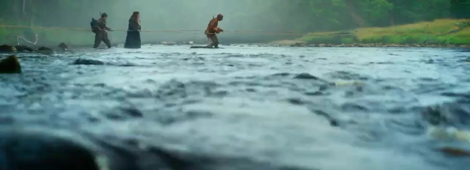 Figures wading across a wide stream in the mist on their way to Kelson's henge